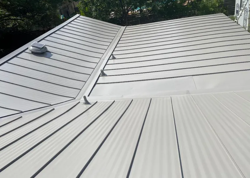 Solar attic fan installed on a metal roof for Roof Ventilation in Ellicott City